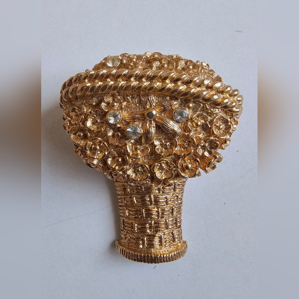 vintage Avon solid perfume brooch in the shape of a gold flower basket.